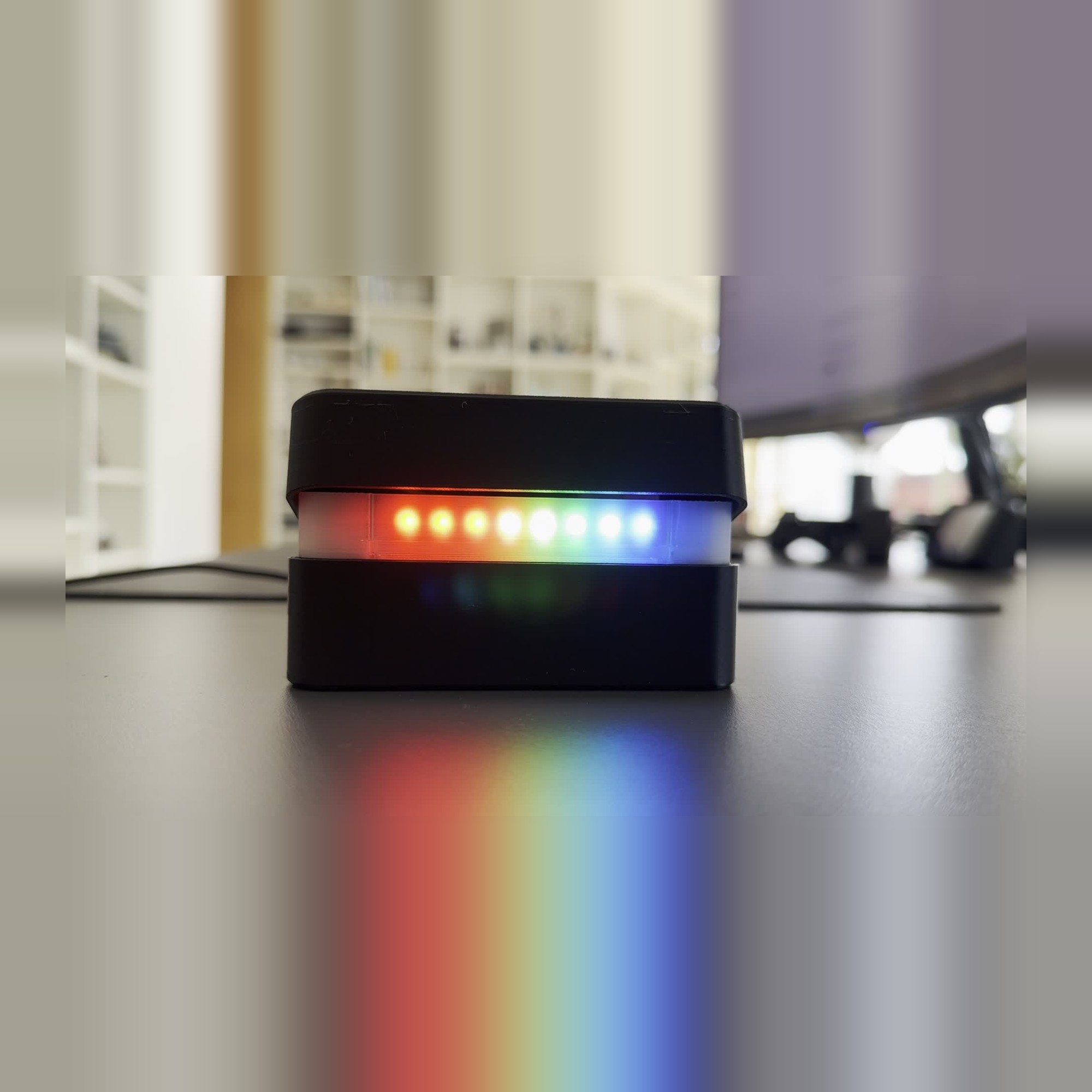 Top lifted, frosted LED band lit in a multi-colour gradient